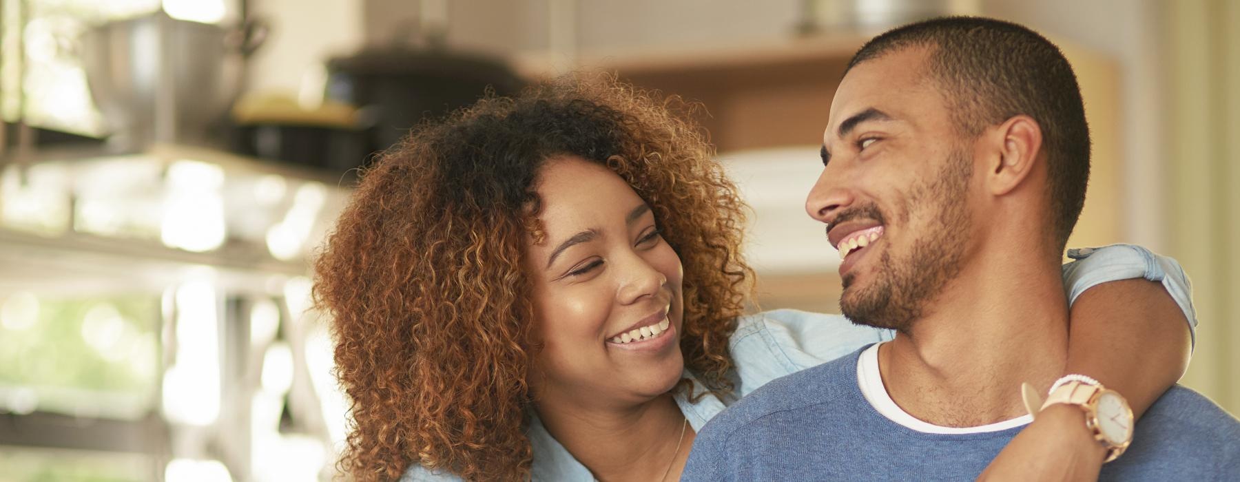 a man and a woman holding a cup and smiling